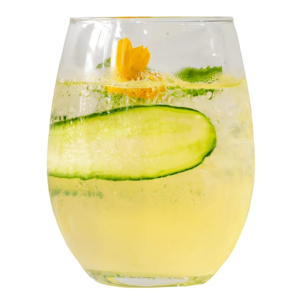Pelican Restaurant's refreshing cocktail with cucumber, mint, and a yellow flower garnish.